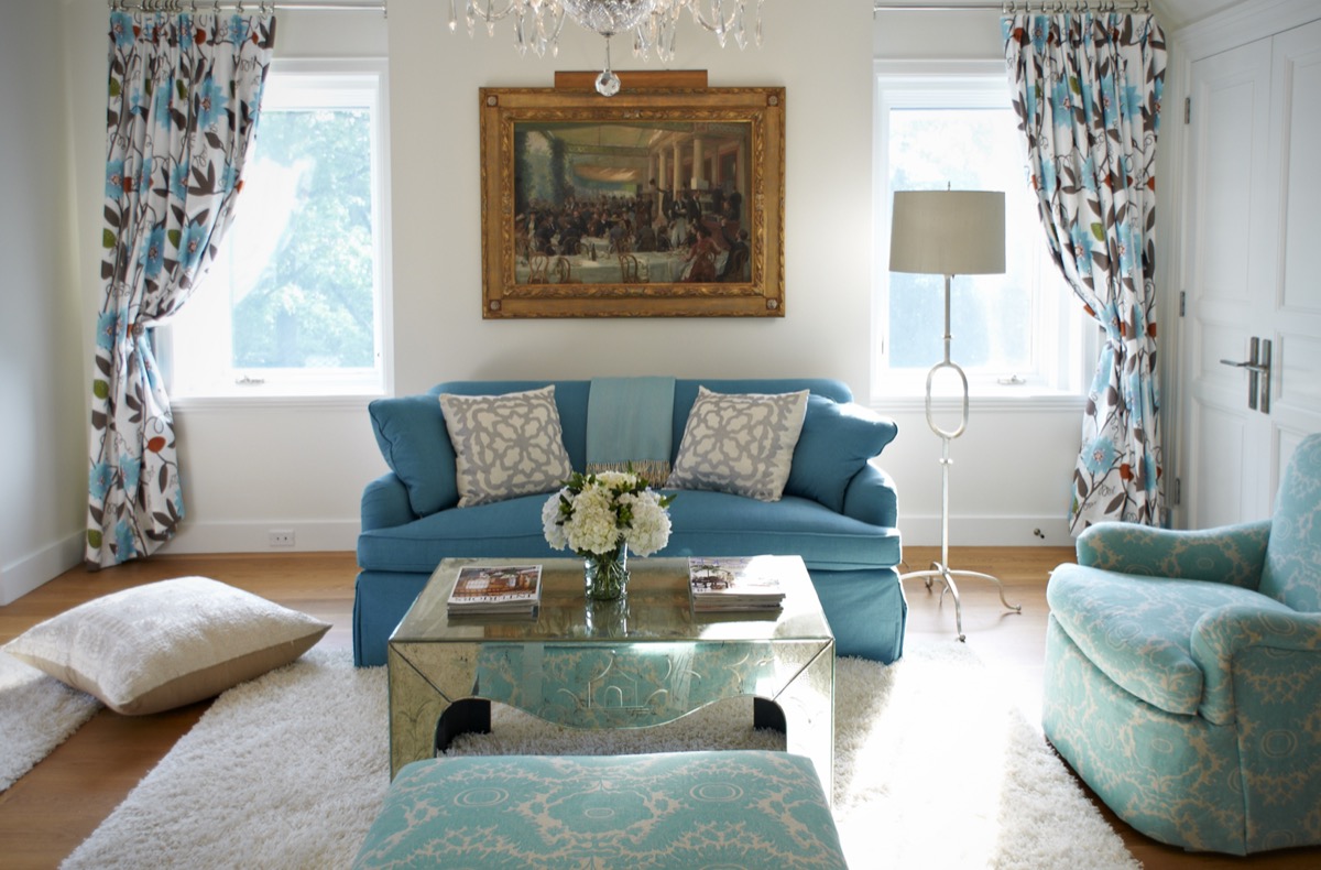 Bedroom sitting area with a blue sofa and floral curtains, Princeton NJ