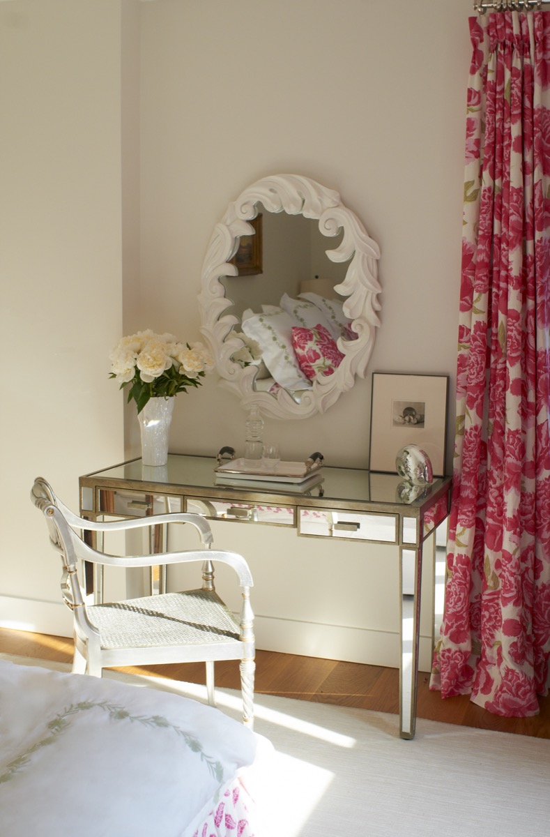 Mirrored vanity with pink floral curtains in a bedroom, Princeton NJ
