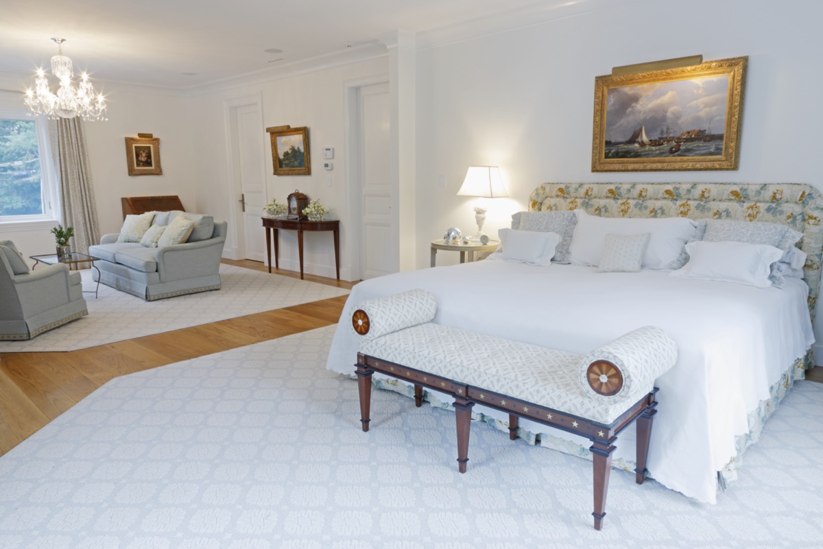 Spacious primary bedroom with a sitting area and chandelier, Princeton NJ