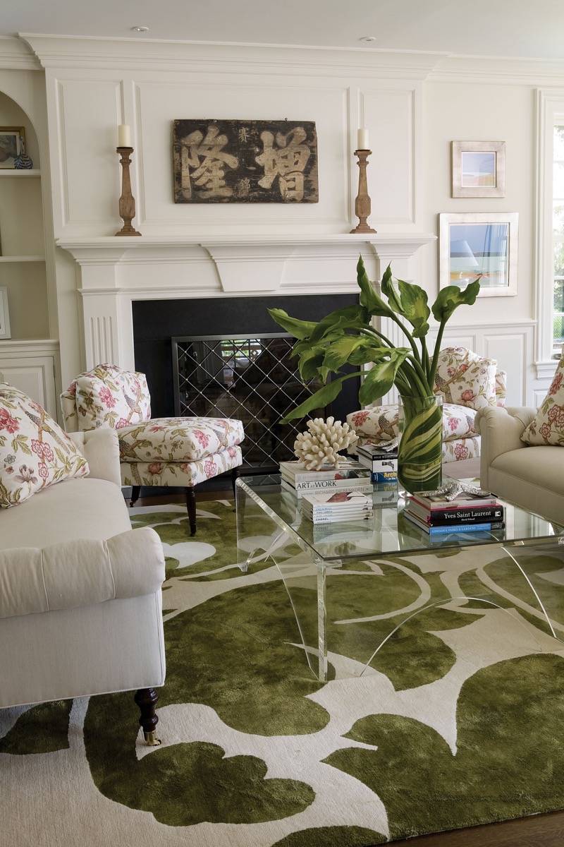 Living room with a white fireplace and floral armchairs, Fairfield CT